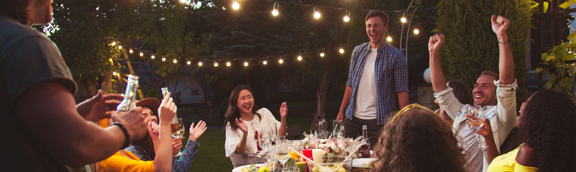banner image of people enjoying a meal in the backyard