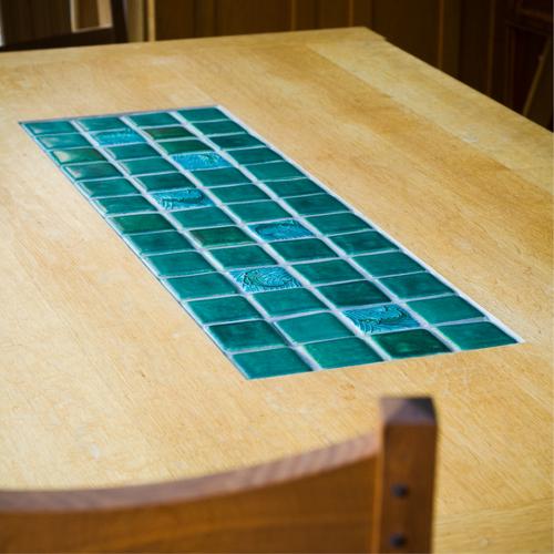 Dining table with Motawi Tile center insert.