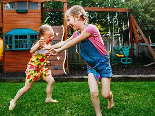 sisters playing in their backyard