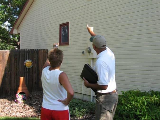 professional pest control service tech inspecting a home with a denver customer