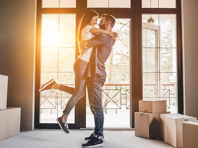 new homeowners hugging in their denver home