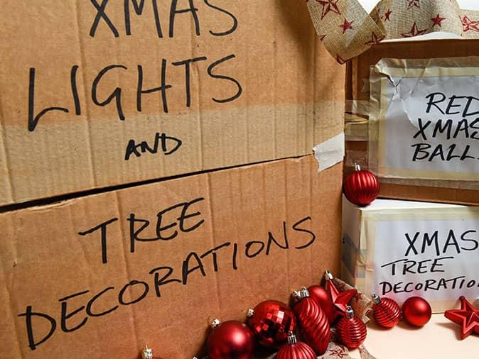 old cardboard boxes holding holiday decorations and lights