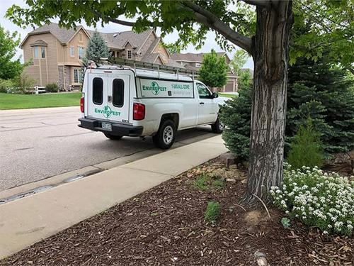 pest control service vehicle parked in a denver neighborhood preventing pests for multiple homes