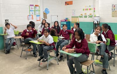 Happy students smile as we come to work at the school.