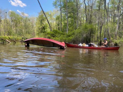 Leadership at its best! One of the scout leaders demonstrating how to unswamp a canoe (unplanned demo :-)