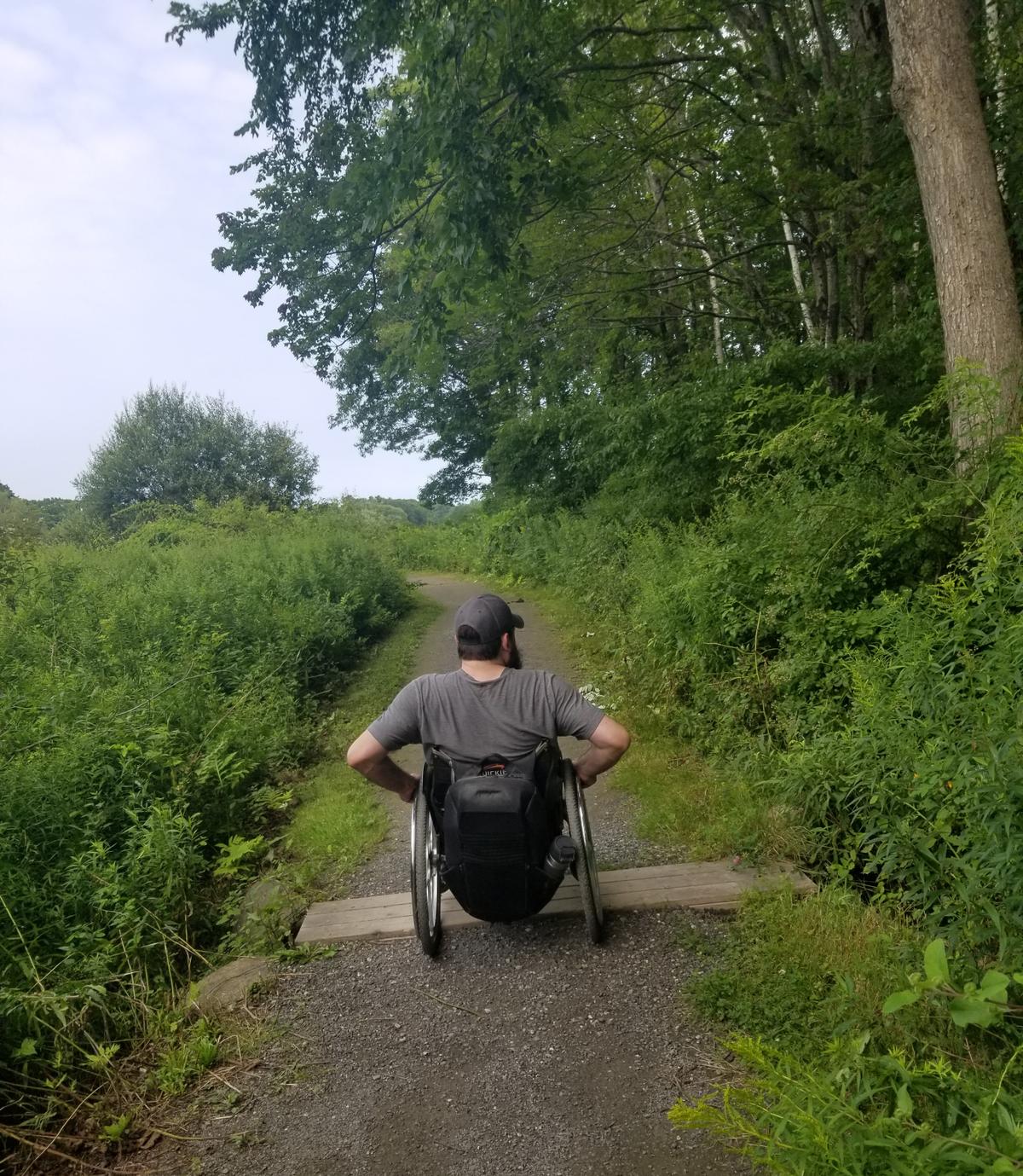 Enock crossing a short boardwalk on Eleanor's Trail. Photo credit: Enock Glidden