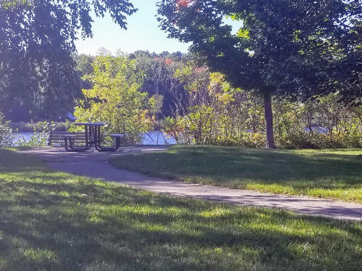 A picnic table along the Kennebec River. Photo credit: Enock Glidden