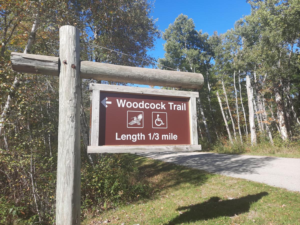 Entrance sign for the Woodcock Trail. Photo credit: Enock Glidden