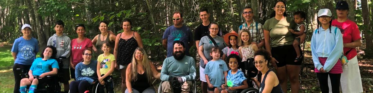 A group of hikers from Enock's guided hike smiles at the camera