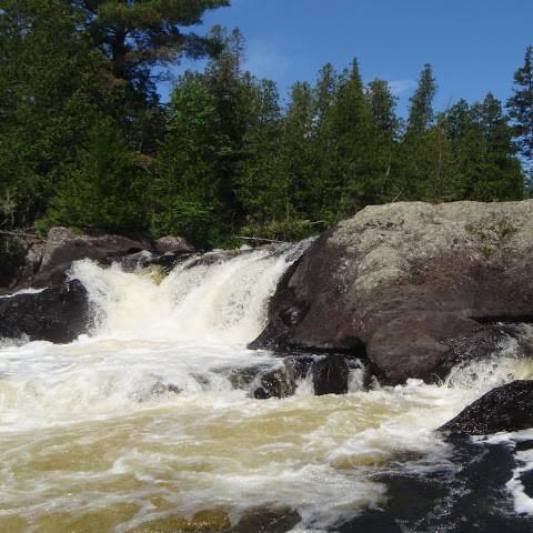 A waterfall over large rocks