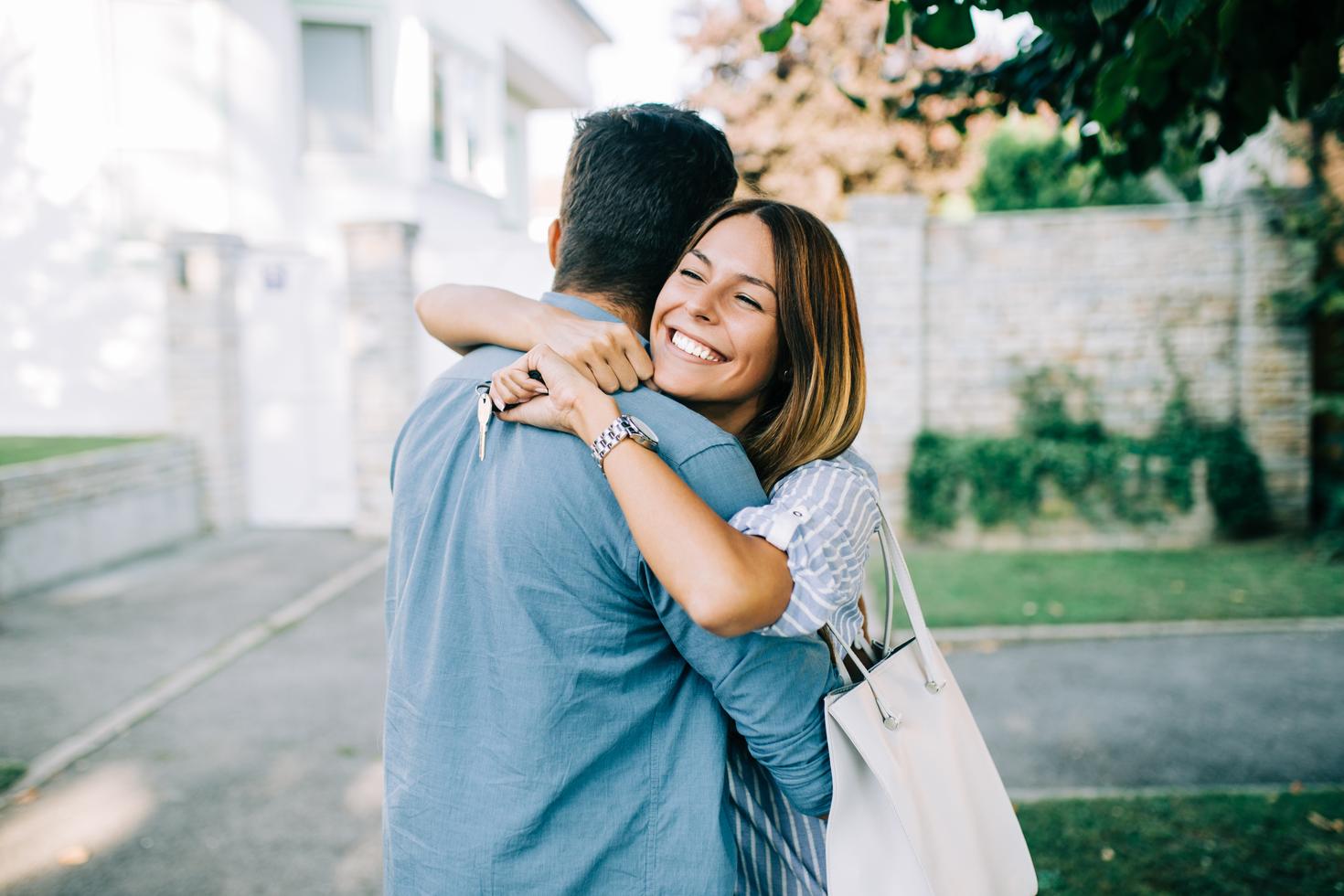 A couple holding a pair of keys