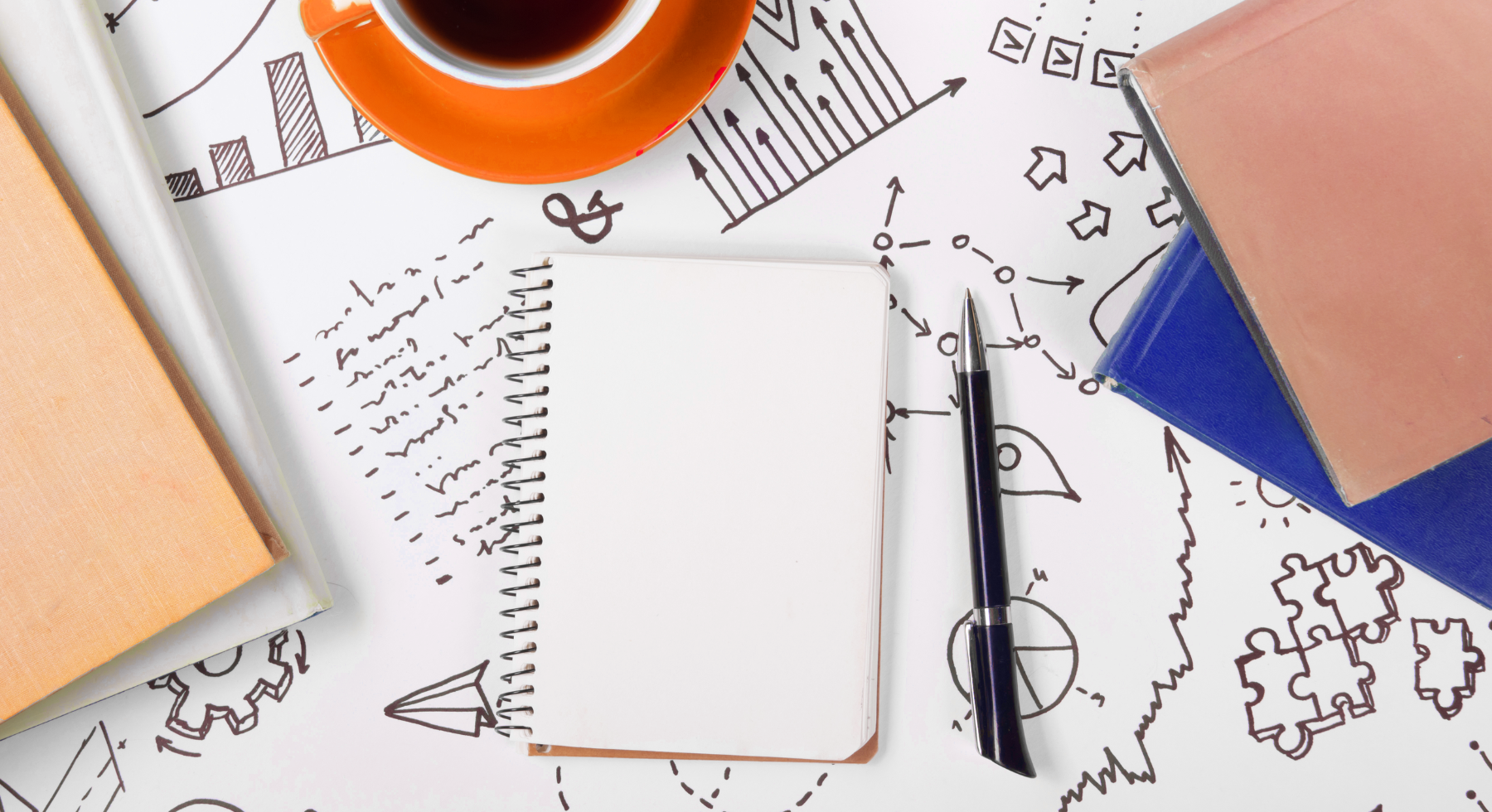 Two people speaking to a third in front of some paperwork and a laptop