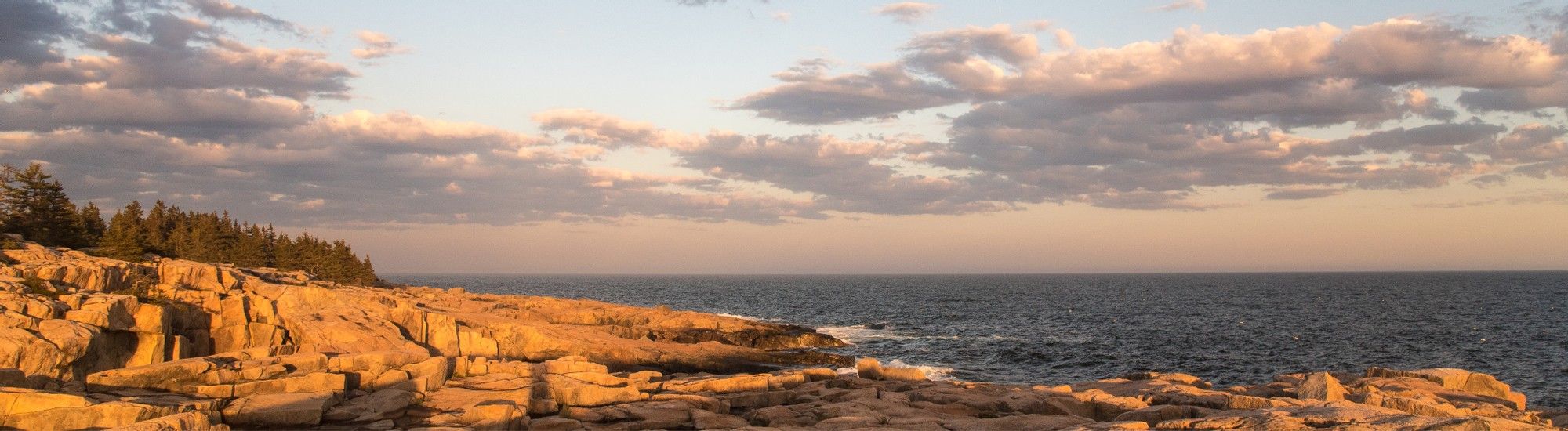 Sunrise on rocks at ocean's edge