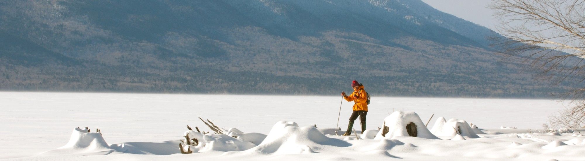 Skier on snow in front of mountain