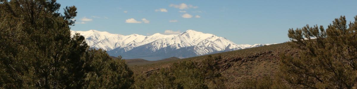 Snowcapped peaks rise above the foothills
