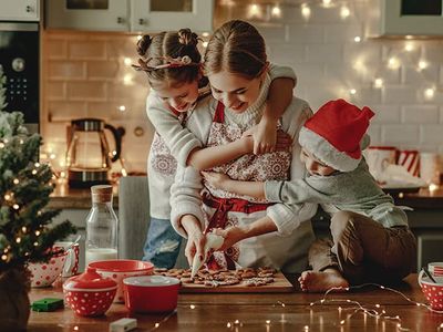 mom and kids making holiday cookies