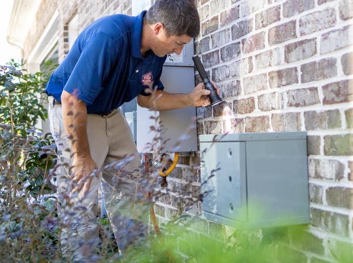 pest control specialist inspecting foundation