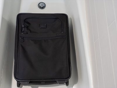 suitcase in tub during bed bug inspection
