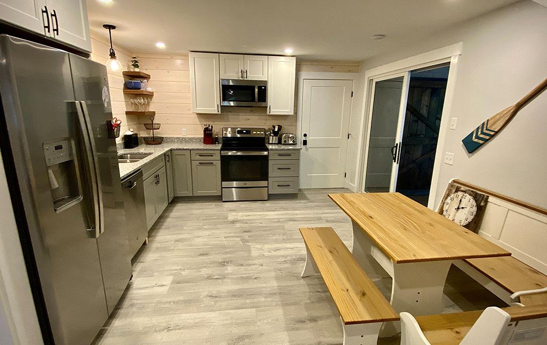 kitchen in cabin with table and sink and stove and refrigerator
