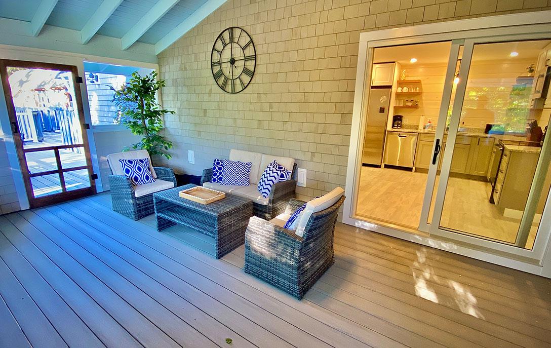 sun porch with furniture and sliding door to kitchen