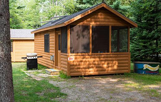 wooden cabin with screened in porch