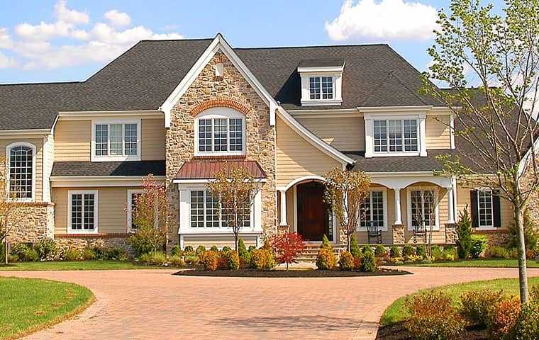 a large beige three story house