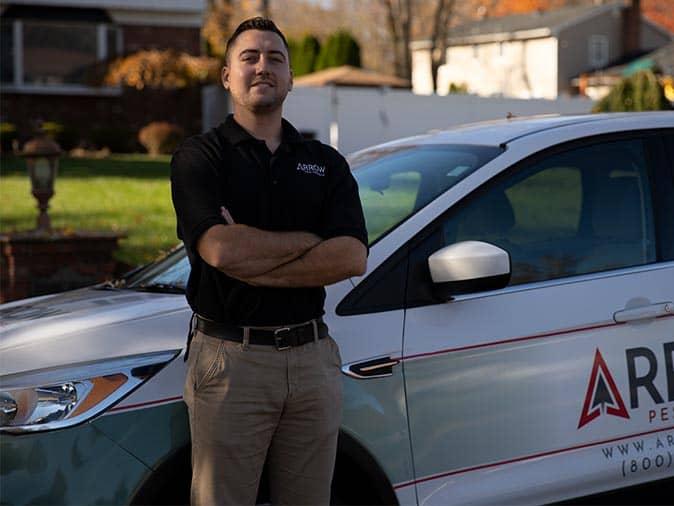 professional pest control tech outside a new jersey home