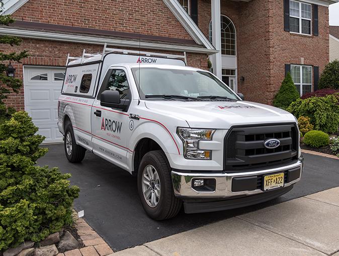 pest control service truck outside a new jersey home