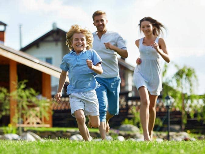 happy family running on a tick free lawn