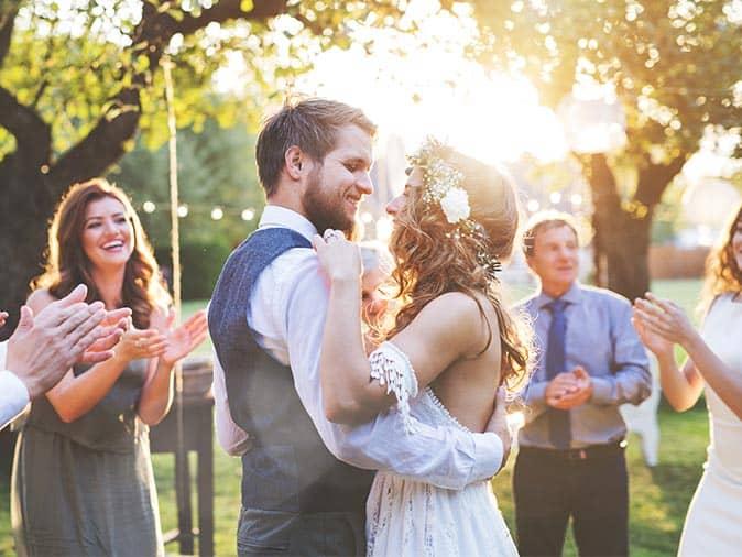 happy couple married outside without mosquitoes or ticks biting their guests