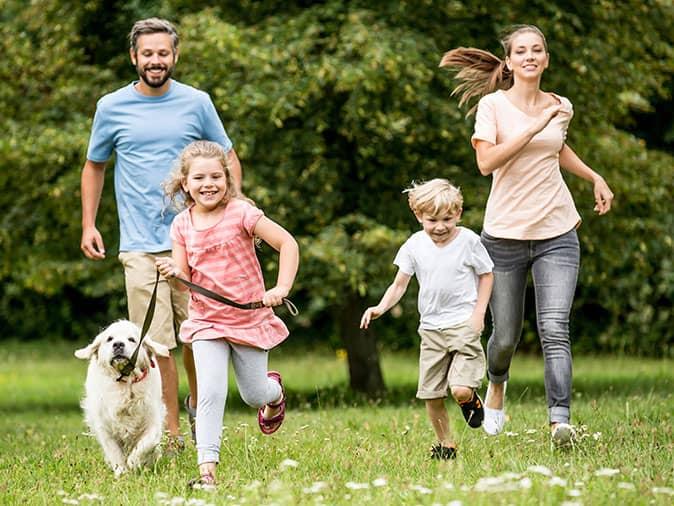 a nj family playing outside with their dog