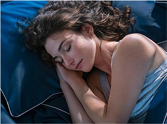 woman sleeping in a bed with bed bugs