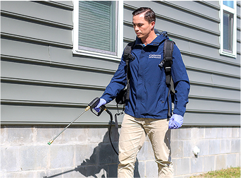 getem pest control technician spraying for fire ants