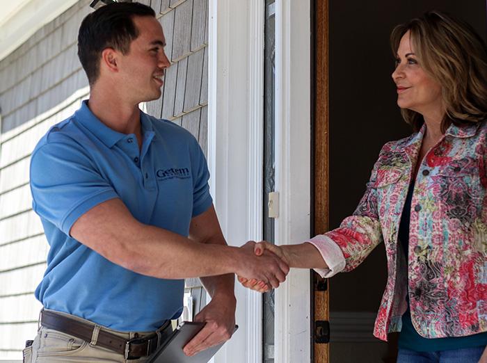 friendly pest control specialist greeting hampton roads homeowner