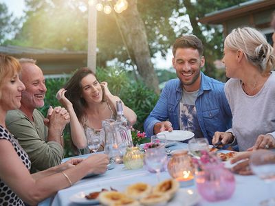 people laughing around backyard table