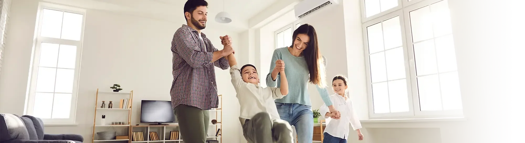 A family swinging their children.