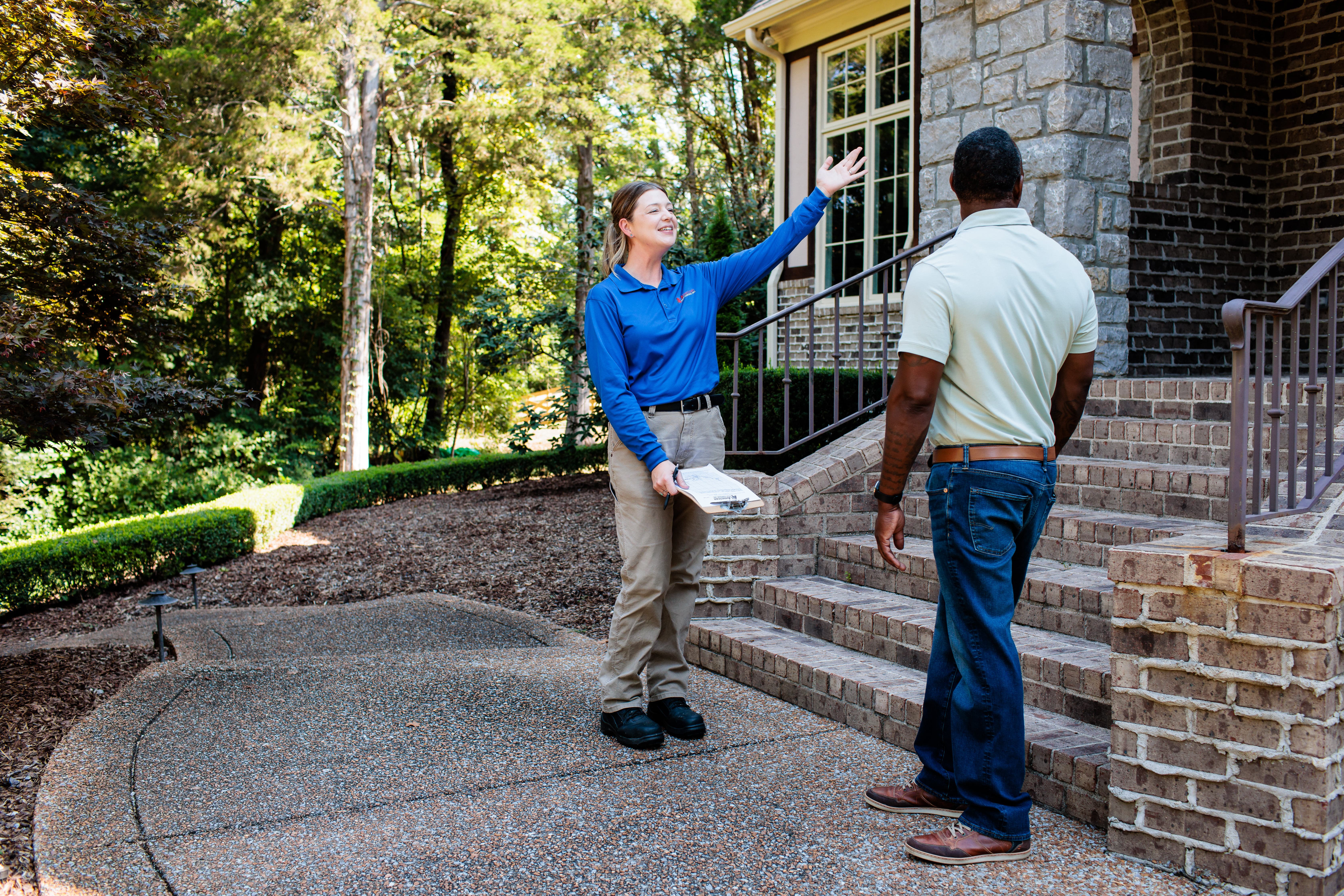 Pest control expert explaining services to customer