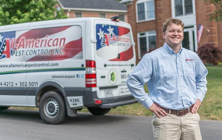 pest expert in front of van