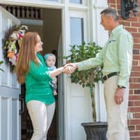 all-american technician greeting a customer