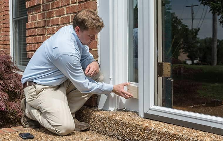 Protect Your Nashville Home From Pest Damage a professional pest control technician inspecting a home in nashville tennessee