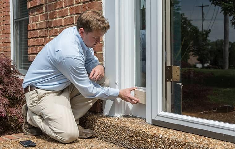 a professional pest control technician inspecting a home in nashville tennessee