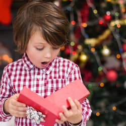 child opening a Christmas gift