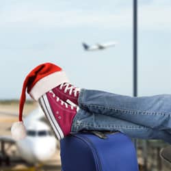 person waiting in airport for holiday flight