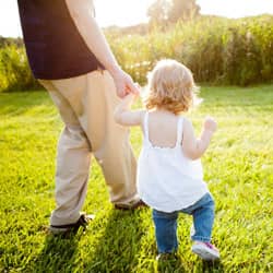 father and daughter walking in a pest free yard