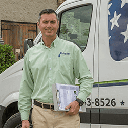 friendly all-american tech standing in front of a service van