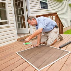 a technician preparing a window screen for pest prevention