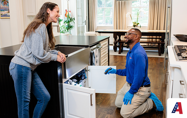 homeowner with pest expert inspecting kitchen