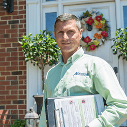 tech in front of a home