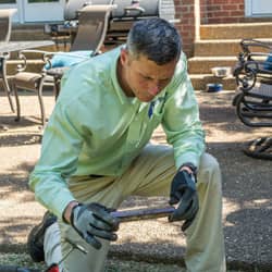 all american pest control technician inspecting for termites