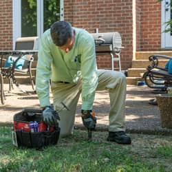 termite technician checking bait station